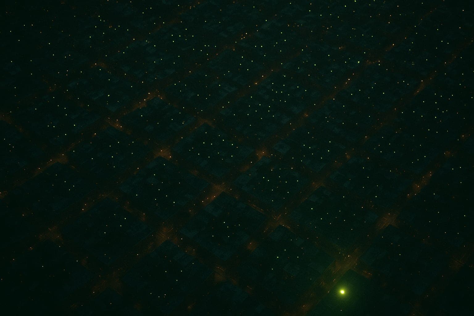 A city at night seen from above, with thousands of small lime lights