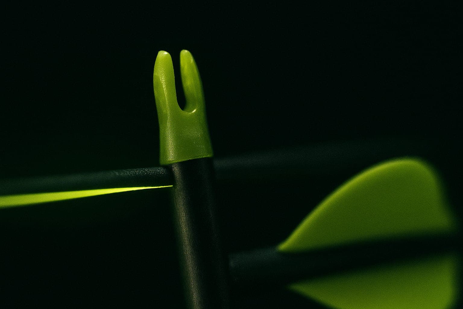 An arrow nock set on a bowstring, lit by a thin lime line